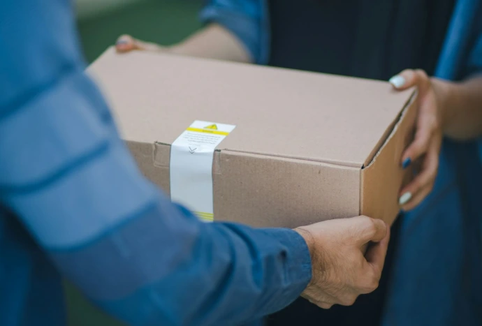 person giving brown box